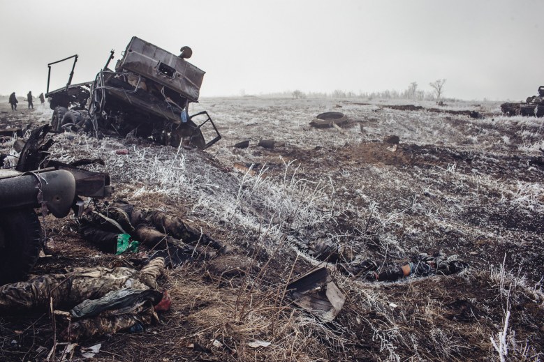 Destroyed Ukraine military vehicle with dead Ukraine soldier on the outskirts of Debalstseva. This is how it ended.
