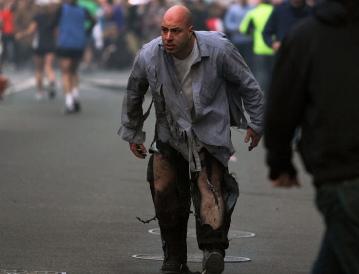 Props mismatch idicates the truth. The clothes are shredded by shrapnel that failed to break the skin. This is impossible. This is costume shredding. 