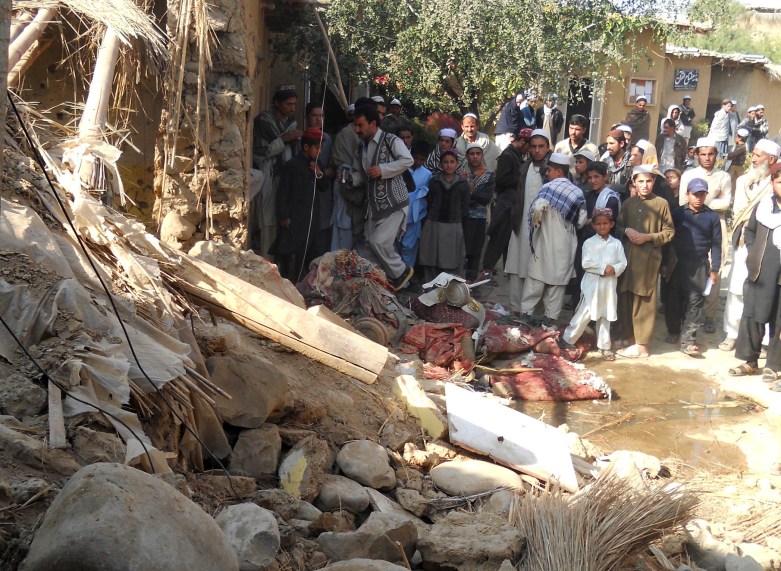 Students gather at the site of a suspected U.S. drone strike on an Islamic seminary in Hangu district