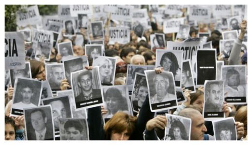 AMIA victims relatives hold photos of their murdered loved ones. 