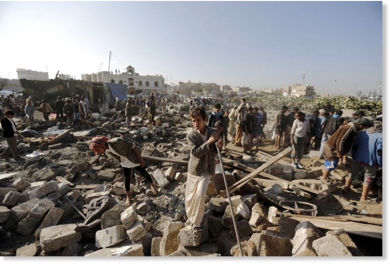 A young Yemeni surveys the devastation in the aftermath of A Saudi airstrike on his nation.
