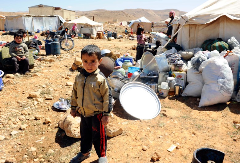 A Syrian refugee child who fled the violence from the Syrian town of Flita, near Yabroud, poses for a photograph at the border town of Arsal, in the eastern Bekaa Valley March 20, 2014. 