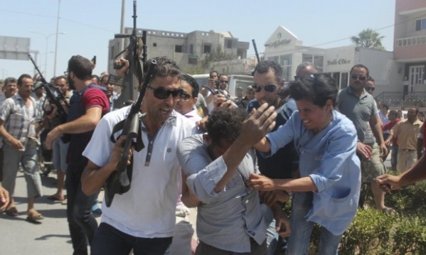 This photograph shows one of the alleged gunmen in the Sousse massacre in custody..