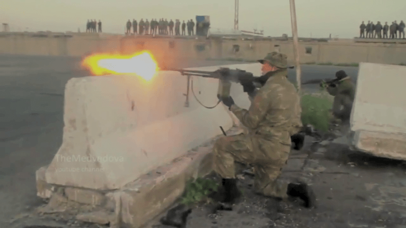 Russian forces perform infantry combat drills in Tartarus Syria as curious locals look on from above.