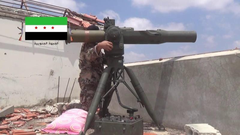 Stock image of a Syrian rebel fighter preparing to fire anti tank rocket from a concealed position.