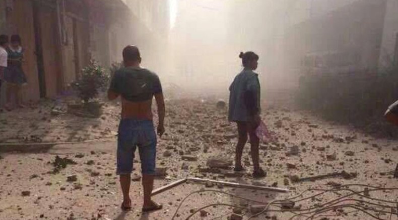 People look on after explosions hit Liucheng county, Guangxi Zhuang Autonomous Region, China, September 30, 2015. 