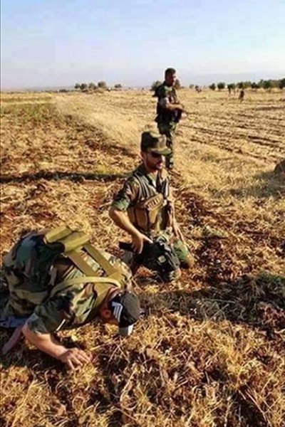 Syrian Army soldiers celebrate the breaking of the Kweires Airbase siege.
