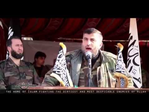 Zahran Alloush addresses a Jaish al islam military parade in the Damascus countryside in April 2015.