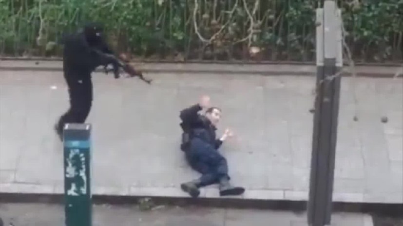 Phot of the year 2015. Pretend terroirst pretend killing of a frenchmen pretending to be a police officer, Paris, January 7th, 2015.