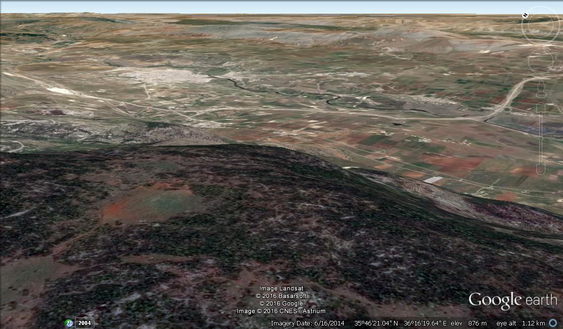 Looking from the Latakia mountains down into al Nusra held Idlib province. The town of Jisr ash Shigour is the white patch in the upper left, at a distance of around 7 kilometres.