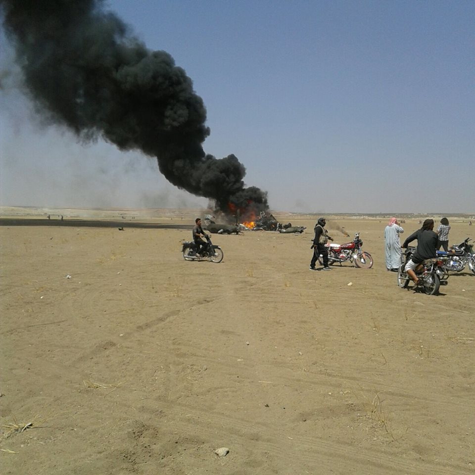 The wreckage of the downed Russian MI8 helicopter burns near the Idlib town of Saraqib yesterday. 