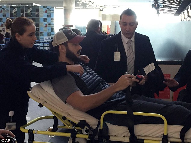 Jacob Raak leaves hospital and his thin, skin tight pants make it clear that there are no bandages on his right leg less than two days after being shot by an assault rifle.